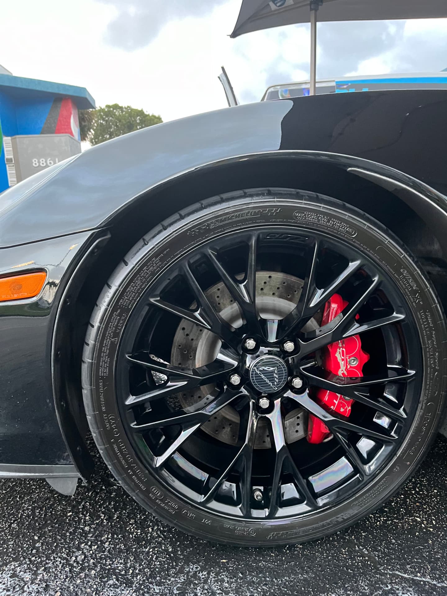 Front wheel, tire and red brake caliper detailed by hand