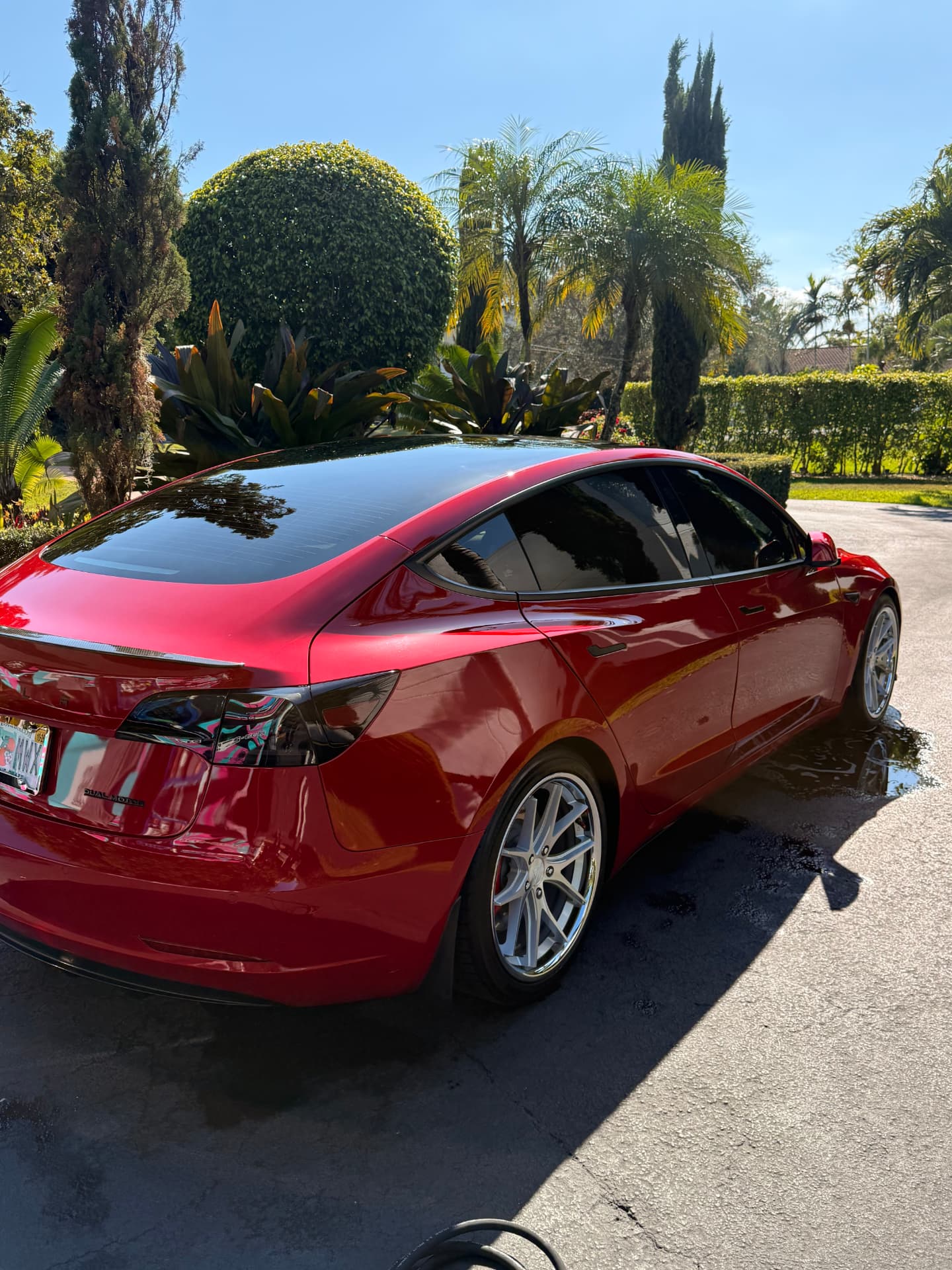Deep red sedan, rear panels and tires finished by hand