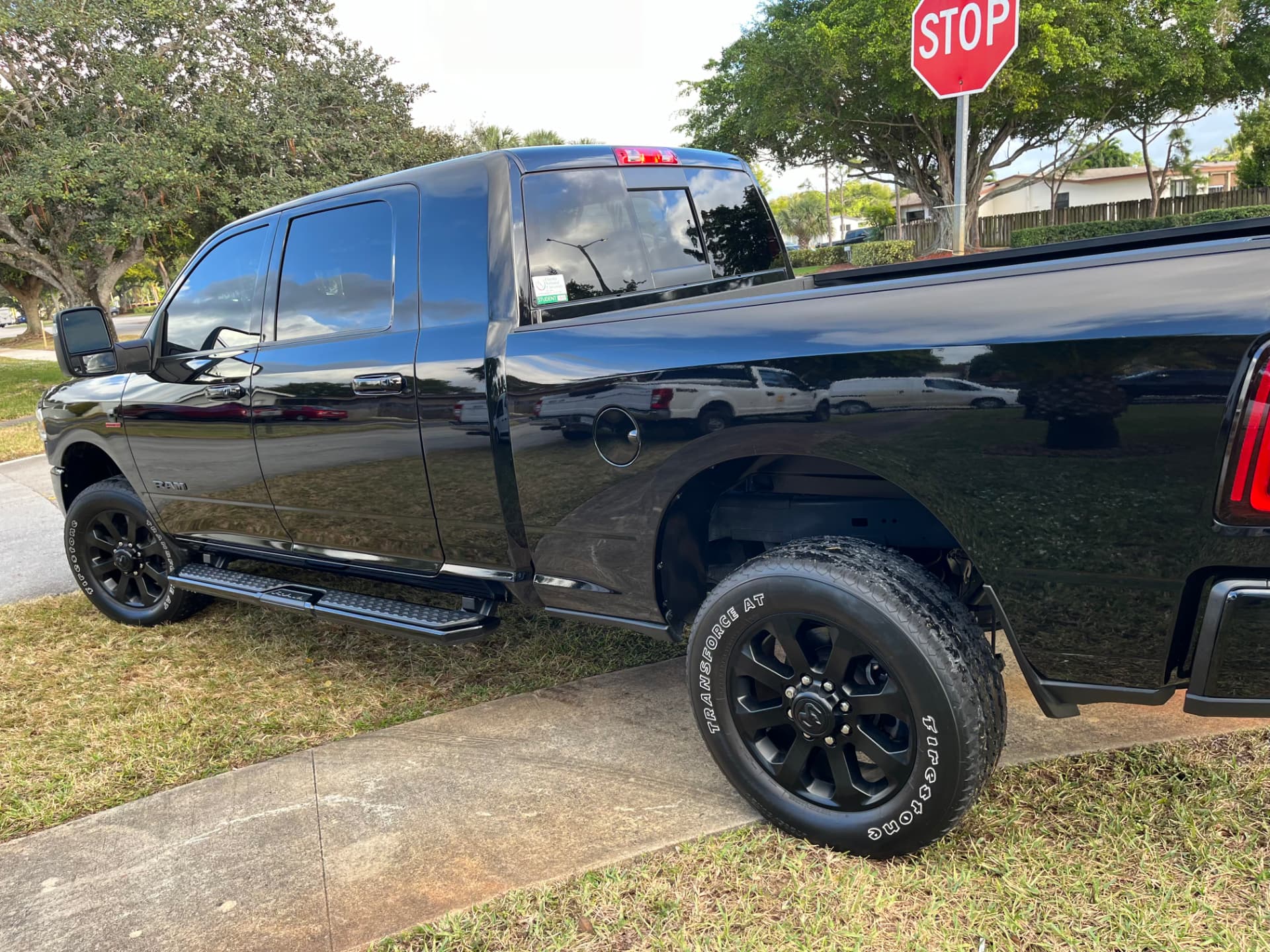 Black pickup down the side, paint and tires freshly dressed