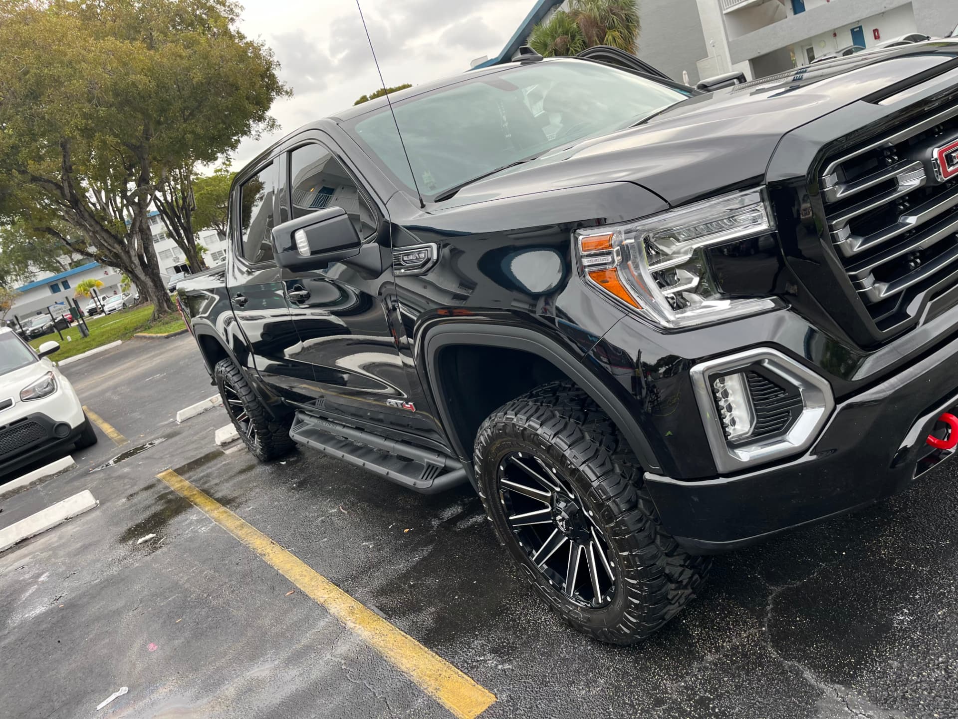 Black pickup, front three-quarter after a full exterior detail